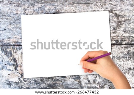 white sheet of paper on the oak gray table with hand