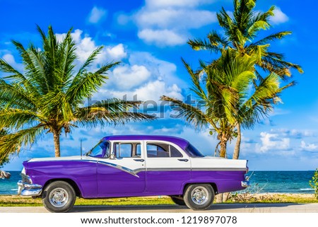 Havana, Cuba - June 30, 2017: HDR - American blue classic car parked on the Malecon near the beach in Havana Cuba - Serie Cuba Reportage
