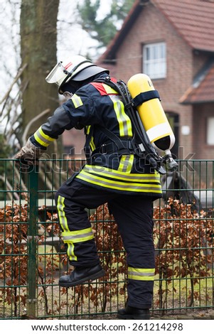 Firefighter in action with oxygen cylinder