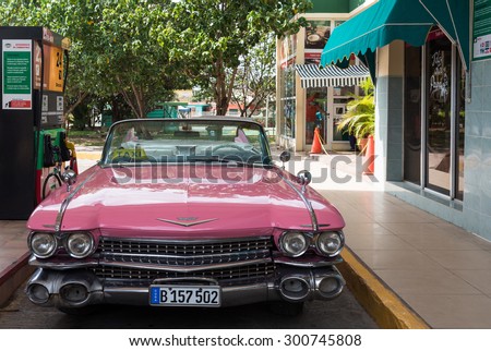 VARADERO, CUBA - JUNE 19, 2015: Pink Oldtimer refuel at the gas station