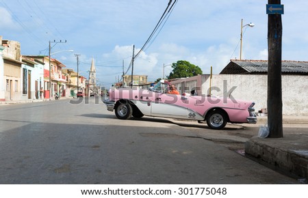 VARADERO, CUBA - JUNE 19, 2015: Pink American Oldtimer drives on the street in Varadero