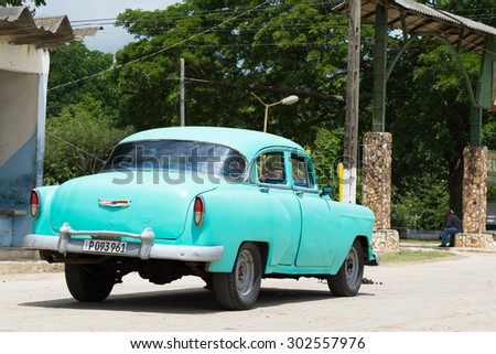 CIENFUEGOS, CUBA - JUNE 21, 2015: Green american vintage car parked on the street in the countryside