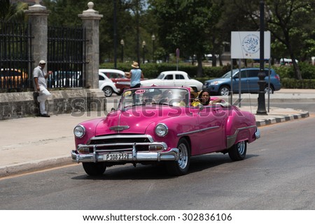 HAVANA, CUBA - JULY 05, 2015: Pink american Oldtimer drives on the Malecon promenade in Havana