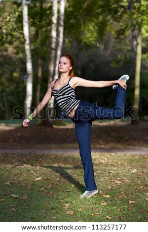 Young woman stretching muscles before jogging