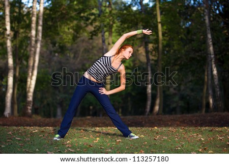 Young woman stretching muscles before jogging