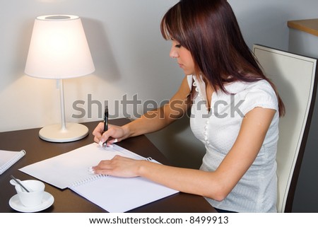 Attractive young woman signing contract