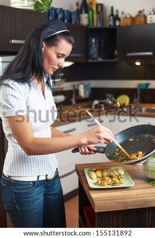 Young woman serve food in home kitchen