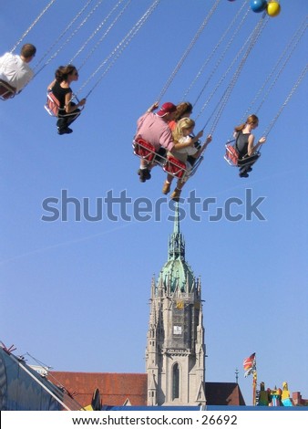 Carousell participants above a church steeple