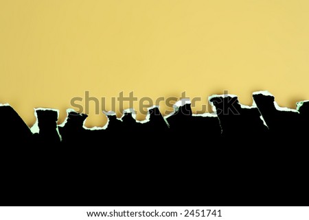 Black card rough jagged tear on a yellow background