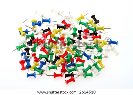 A colourfull pile of drawing pins rndomly piled on a white background