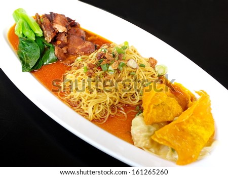 Egg chinese dry noodles with roast pork, dumpling