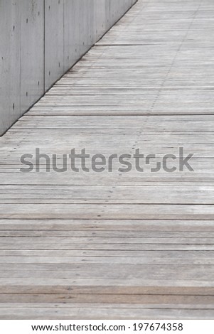 Outdoor wood pathway and concrete wall background