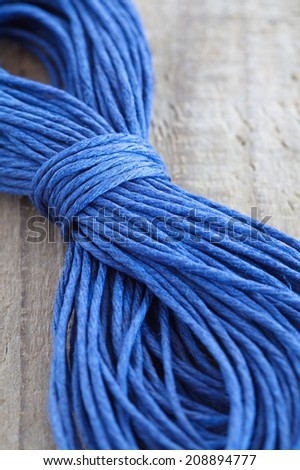 Close - up blue hemp ropes on wooden background