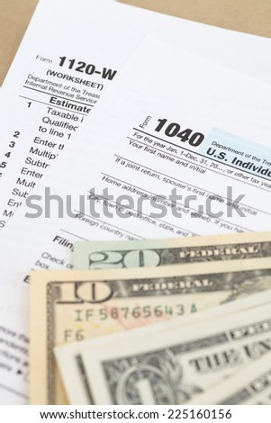 U.S. income tax form and dollar bill