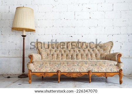 vintage yellow luxury armchair and white brick wall at background