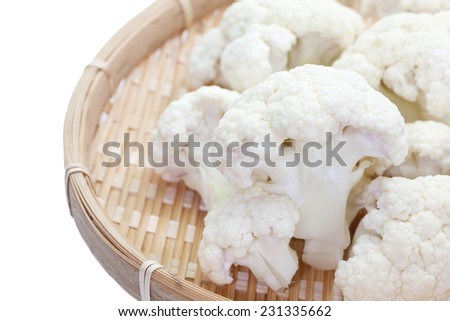 Fresh cauliflower in bamboo tray on white background