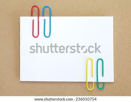 Color metal paper clip and blank white paper note