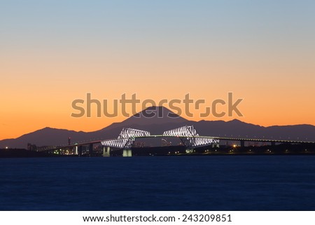 View of Tokyo bay at sunset with Tokyo gate bridge and Mountain Fuji in background
