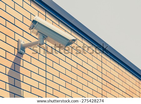 Video camera security system on the wall of the building