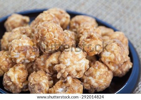 Almond and caramel popcorn on tablecloth background