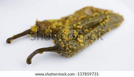 Closeup of spicy indian pickle pepper on white background
