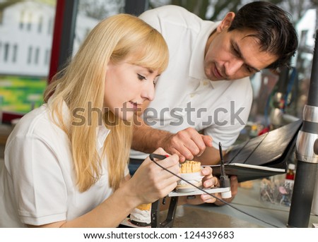Dental technician instructing an apprentice in producing a dental prosthesis
