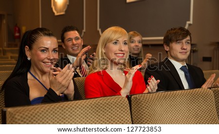 Audience in a theater, on a concert or in a cinema clapping and applauding