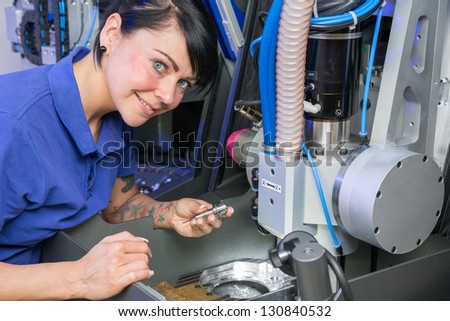 Dental technician working on a milling machine
