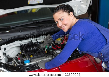 Mechanic repairing the motor or electric parts of a car in a garage