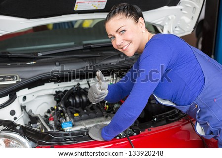 Mechanic repairing the motor or electric parts of a car in a garage