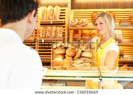 Shopkeeper presents a breadbasket to customer