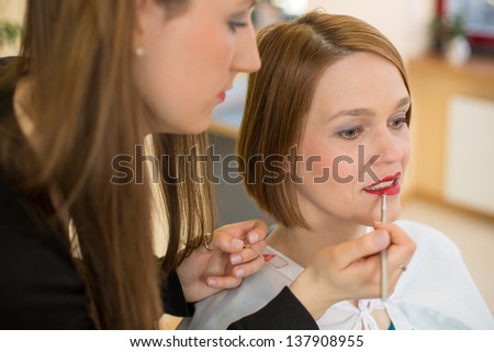 cosmetician lip gloss or lipstick for customer