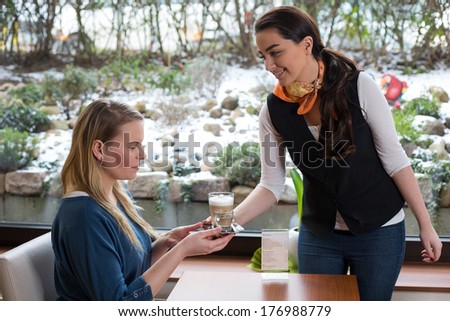 Server in restaurant or cafe serving a guest