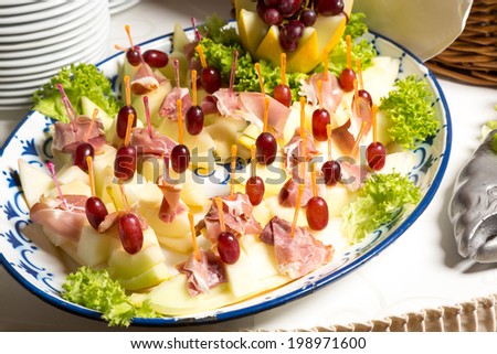 Pineapples with ham on a tray at buffet in restaurant