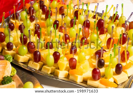 Buffet with pineapple and grapes appetizers and other fruits in a restaurant