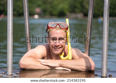 Man with diving goggles in public swimming pool
