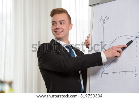 Man giving presentation on flip chart at meeting or congress
