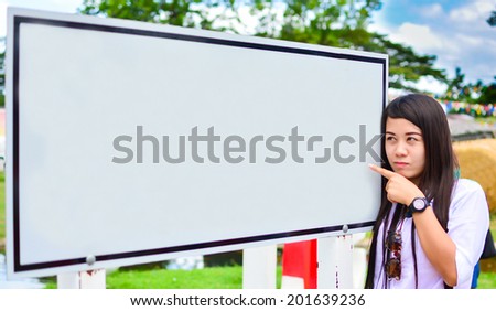 woman pointing to a blank board