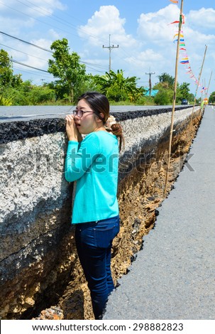 woman frighten after road cracked.