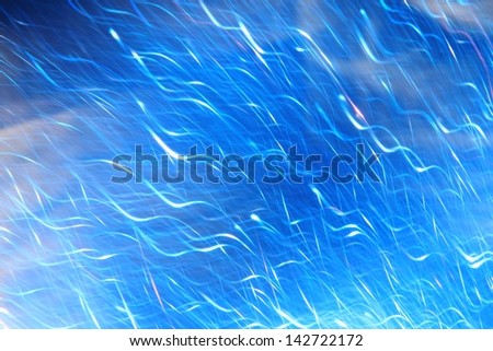 Blue Background - Art, Blur and Texture of Captured Color and Light - Showering light dots on brilliant blue.