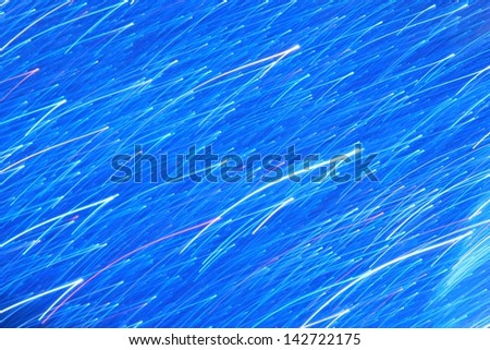 Blue Background - Art, Blur and Texture of Captured Color and Light - Showering light dots on brilliant blue.
