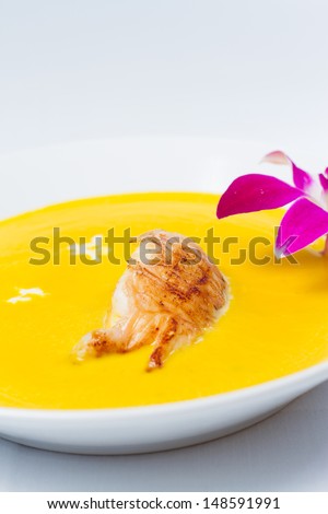 Cream of roasted pumpkin soup accented with grilled rock lobster