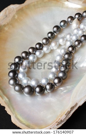 white pearl necklaces and black pearl necklaces on pearl shell