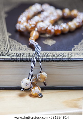 Prayer beads on the Koran. Selective focus