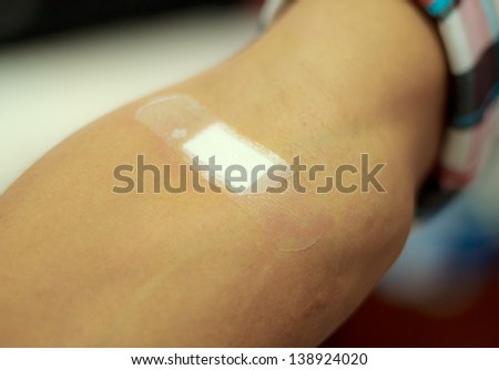 Sticking plaster adhesive plaster on the forearm.