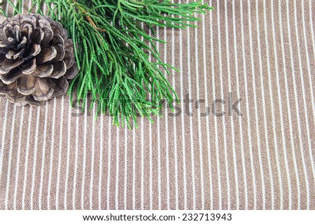 Christmas frame of pine tree branches on brown cloth