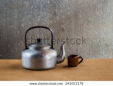 Vintage still life with Kettle on wooden background