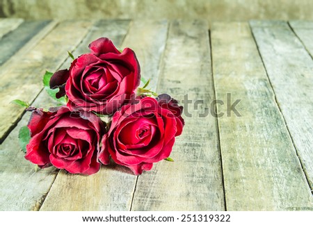 Fresh red rose on a wooden background. Holidays romantic background