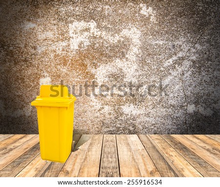 Yellow garbage on wooden floor and grunge texture background