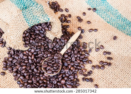 Coffee beans in coffee bag on sack surface background